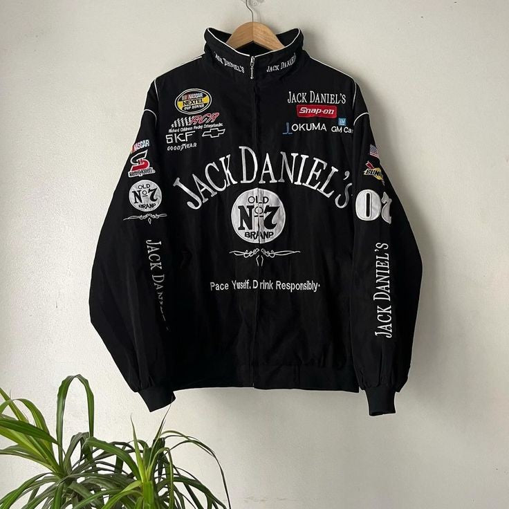 Vintage Jack Daniel's retro racer jacket featuring bold logo patches and classic motorsport-inspired design. The front showcases a zip-up closure with striking black and white contrast, suitable for unisex fashion.