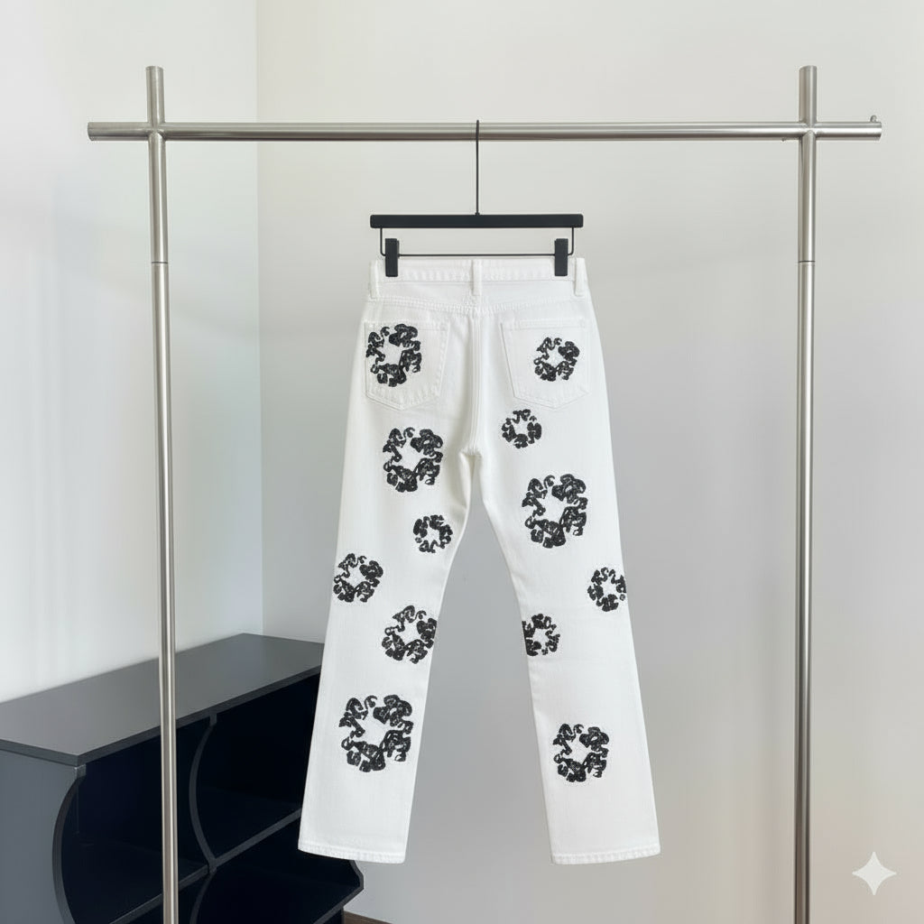 White pants with black floral patterns hanging on a rack