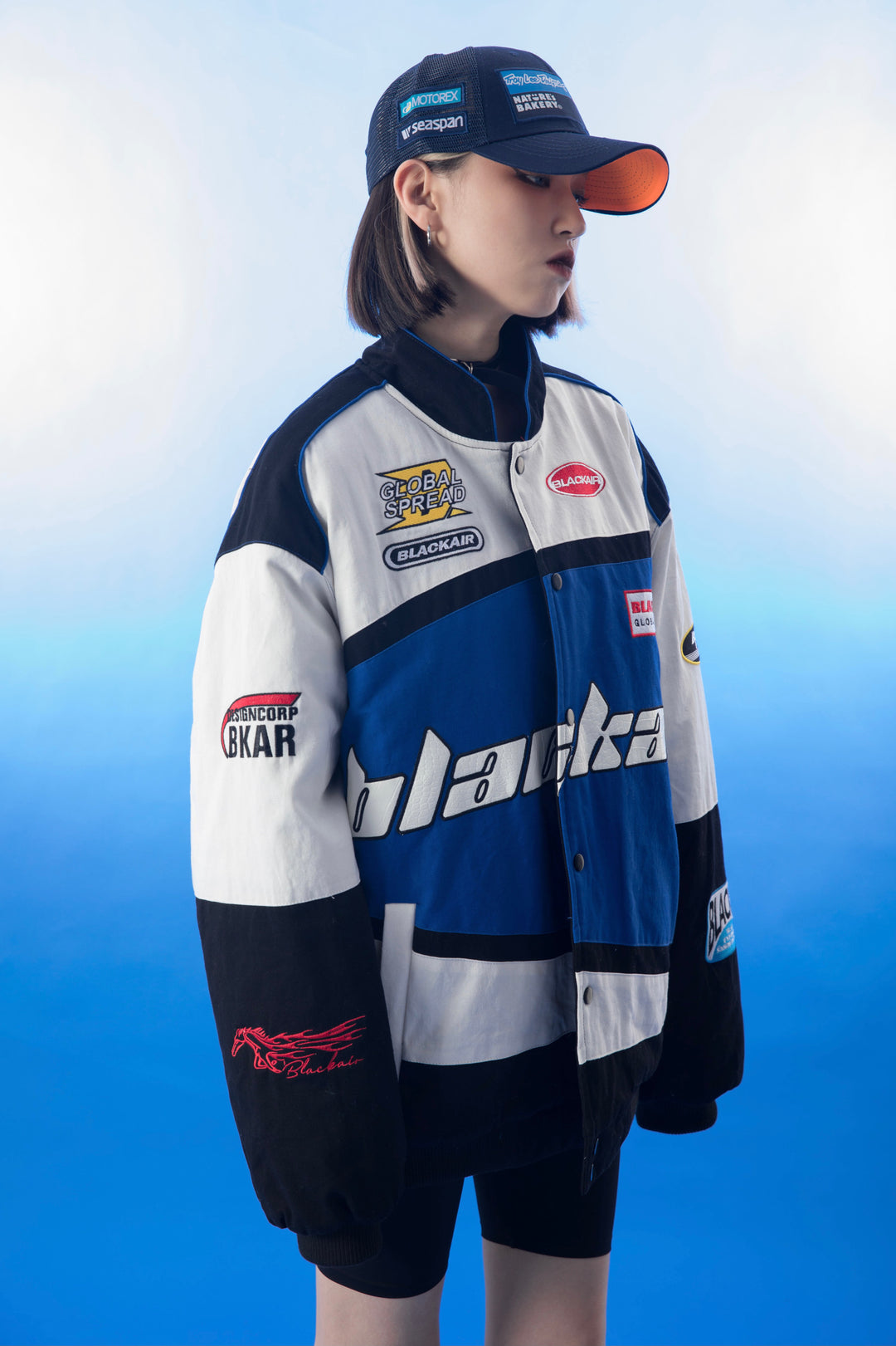 A close-up view of the left sleeve of the vintage Blackair racer jacket, displaying a vibrant retro logo and racing stripes that add a sporty touch to the design