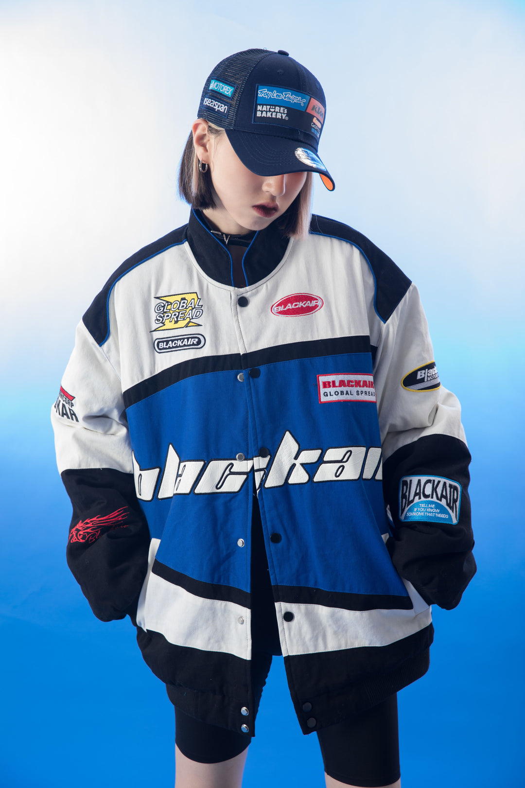 A close-up view of the left sleeve of the vintage Blackair racer jacket, displaying a vibrant retro logo and racing stripes that add a sporty touch to the design