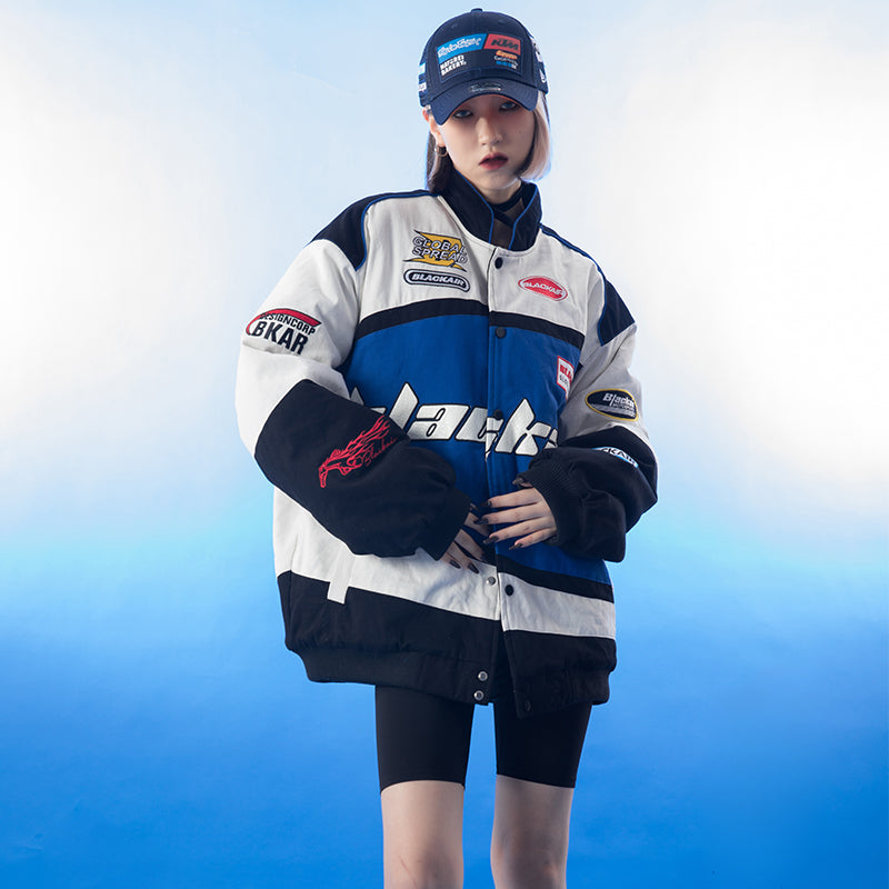 A model wearing the vintage Blackair racer jacket, styled with fitted jeans and sneakers, demonstrating the jacket's trendy oversized fit and stylish appeal in an urban setting.