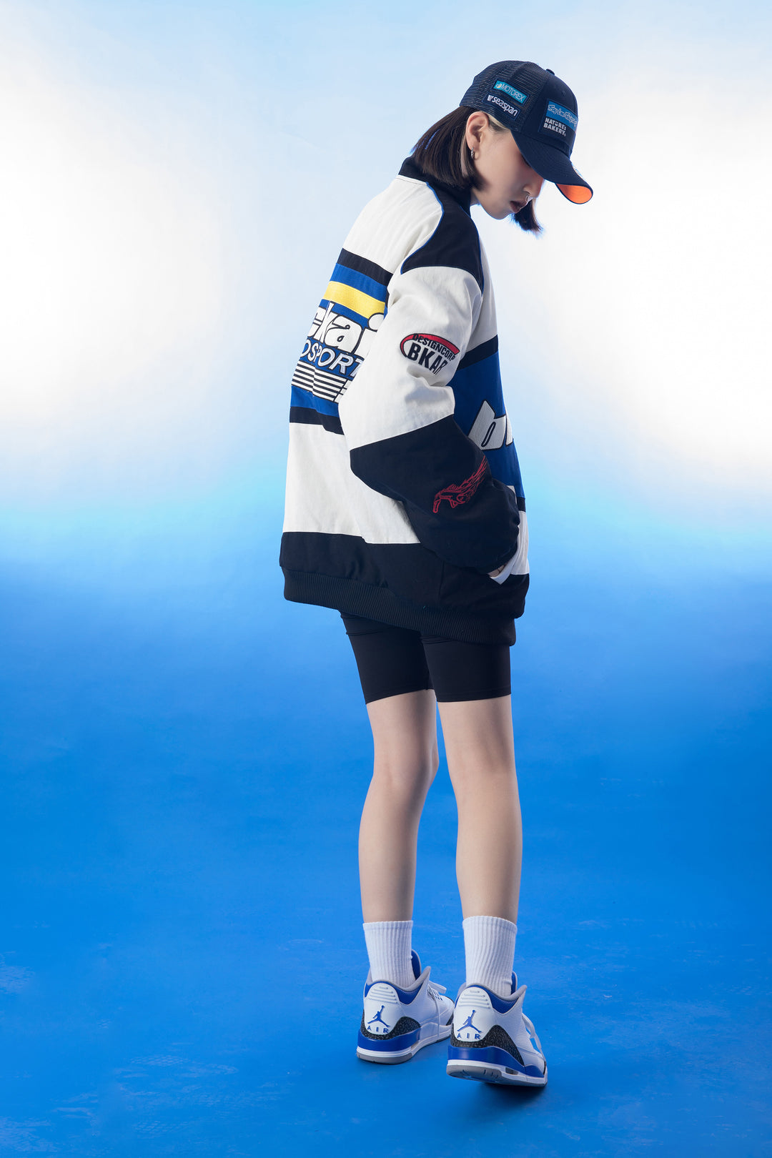 The back view of the vintage Blackair racer jacket, highlighting a large graphic design and retro branding that captures the essence of classic motorsport style.