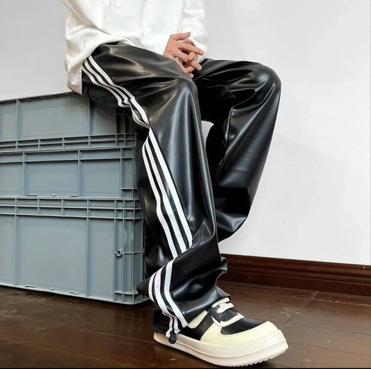 glossy black faux leather track pants with white three-stripe detailing