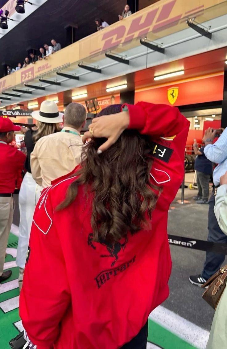 Back view of a limited edition red Ferrari F1 vintage racing jacket showcasing bold branding and a sleek design.