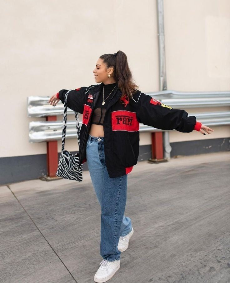 A model wearing the Ferrari F1 racing jacket, paired with casual jeans, demonstrating its stylish and athletic appeal.