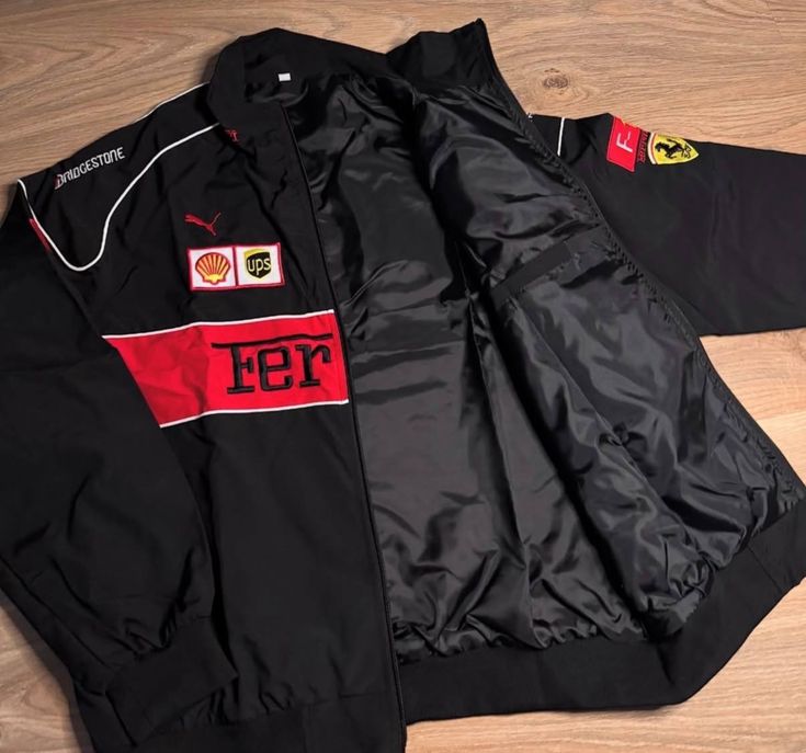 Black jacket with red and white logos on a wooden surface
