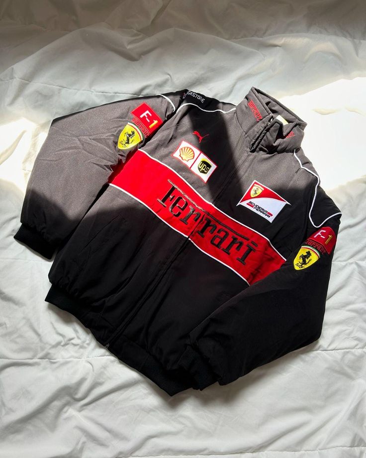 Ferrari racing suit with various logos on a white background