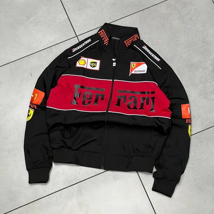 Black Ferrari jacket with red and white details on a gray tiled floor