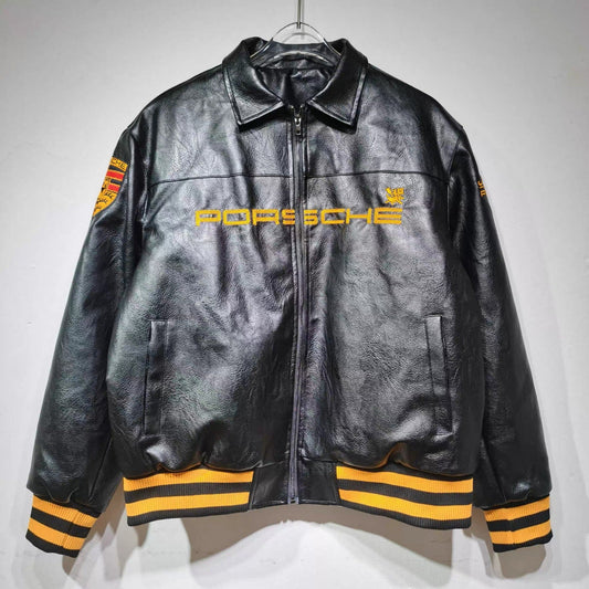Black leather jacket with yellow accents and Porsche logo on a white background