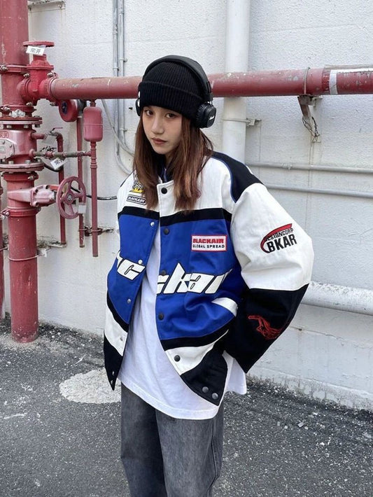 A model wearing the vintage Blackair racer jacket, styled with fitted jeans and sneakers, demonstrating the oversized fit and fashionable appeal in an urban environment.