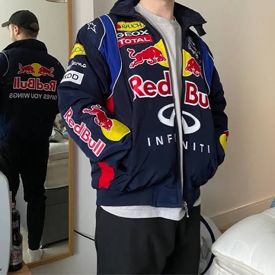 "Vintage Red Bull retro racing jacket featuring a striking design with bold logos and vibrant colors. The jacket has a zip-up front and a sporty silhouette, perfect for motorsport fans and casual wear."